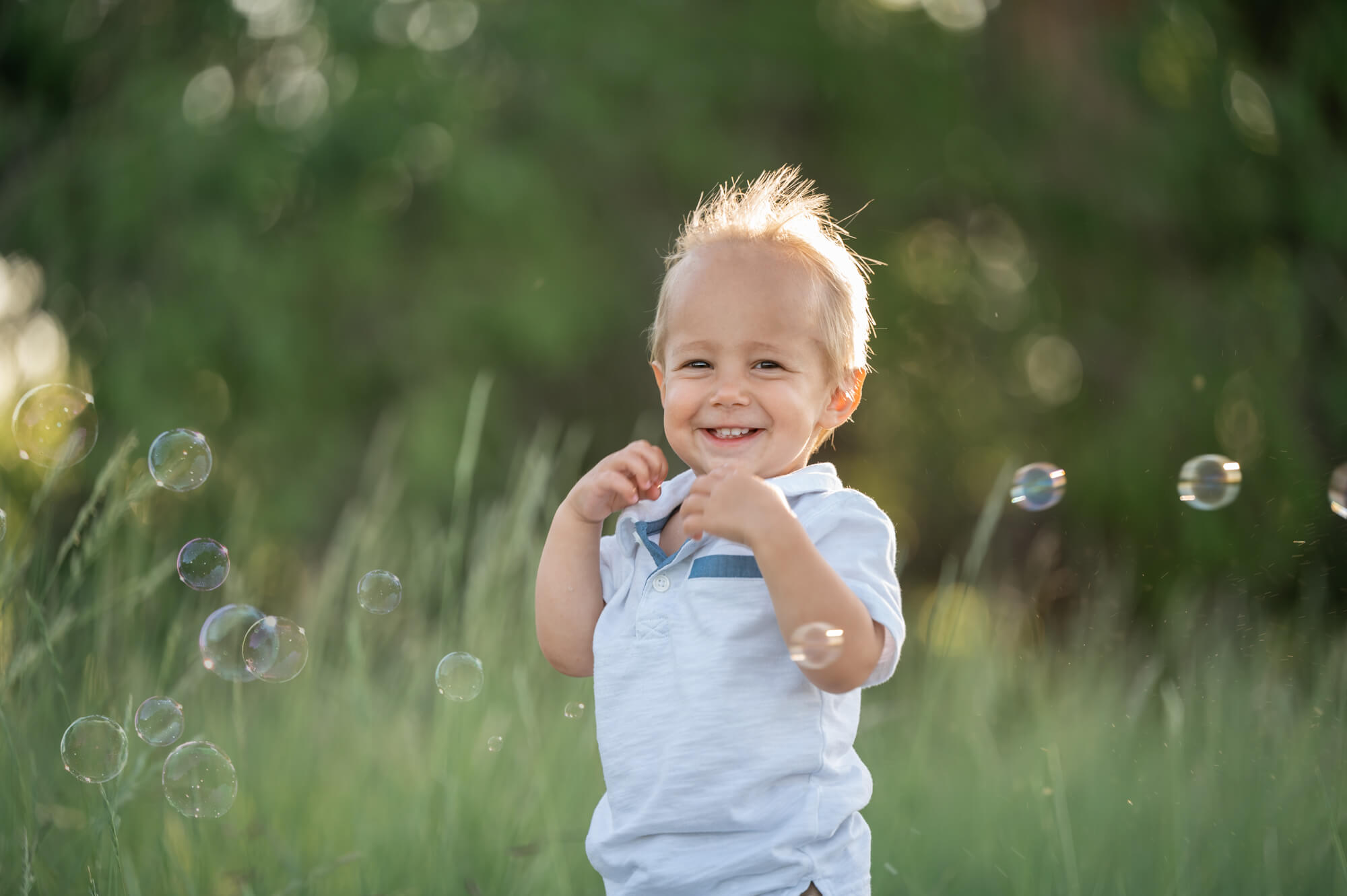 child happy playing with bubbles