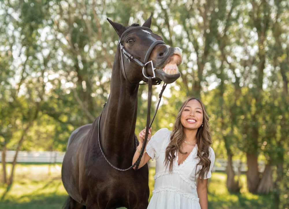 a girl and her horse smiling