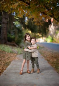 siblings hugging each other wearing outfits from Baby Stores in Denver