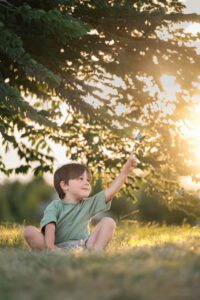 kid trying to touch a butterfly