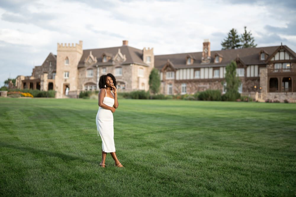 senior girl in front of a mansion