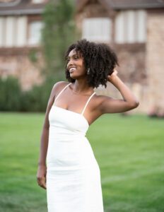 model in front of a yard