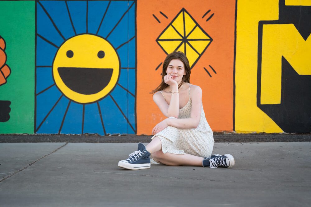 girl in front of a mural