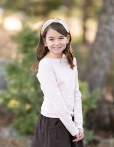 girl posing for photos and playing at a park