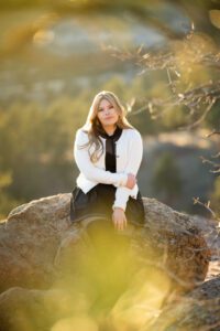 girl framed by trees in her senior session